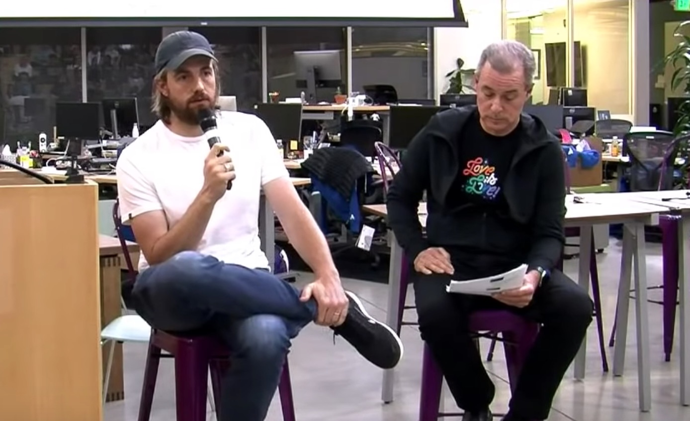 Photo of Atlassian co-CEO Mike Cannon-Brookes and Atlassian CFO James Beer at an all-staff meeting reading questions from staff.